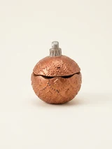 Spherical decorative container with a lid, a silver loop and raised fir trees and bead garlands. Copper and bronze colours with a visible concrete texture.