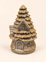 Christmas house with fir tree, small windows and gold branch edges, close-up from the front