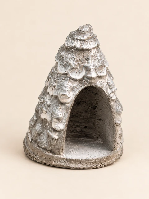 Silver tree form with a large empty arched opening at the front and a raised pattern